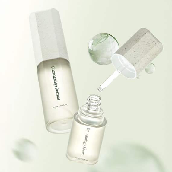 ICD Dermatology Booster and Serum bottles shown together, with the serum's dropper releasing a drop of liquid