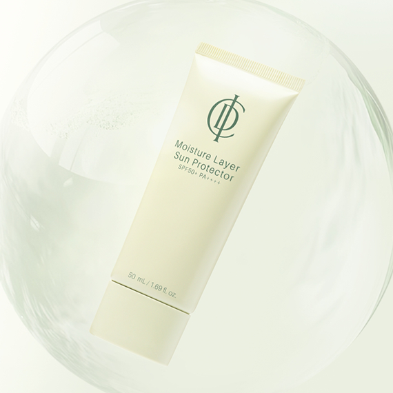 Close-up of a smooth white sunscreen texture swipe on a plain background