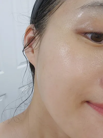 Close-up of a cheek with a dewy, hydrated finish after the routine